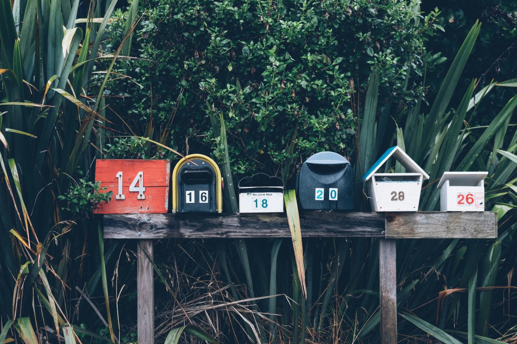 Row of mailboxes in suburban neighborhood being targeted by an investor's direct mail campaign.